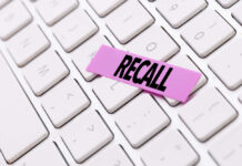 RECALL ALERT: Deadly Warning Issued A pink sticky note with the word 'RECALL' placed on a white keyboard