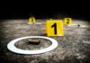 Deadly Chaos As Bullets Fly Crime scene with evidence markers and a bullet casing on the ground