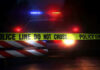 Museum Alarm Snooze Lets Thieves Stroll Police car with flashing lights behind caution tape.
