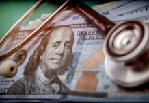 Hospitals Demand Cash First — Or No Care A stethoscope resting on a stack of hundred-dollar bills