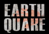 Quake Relief Goes Prime Time Concert crowd with hands raised, bright stage lights.