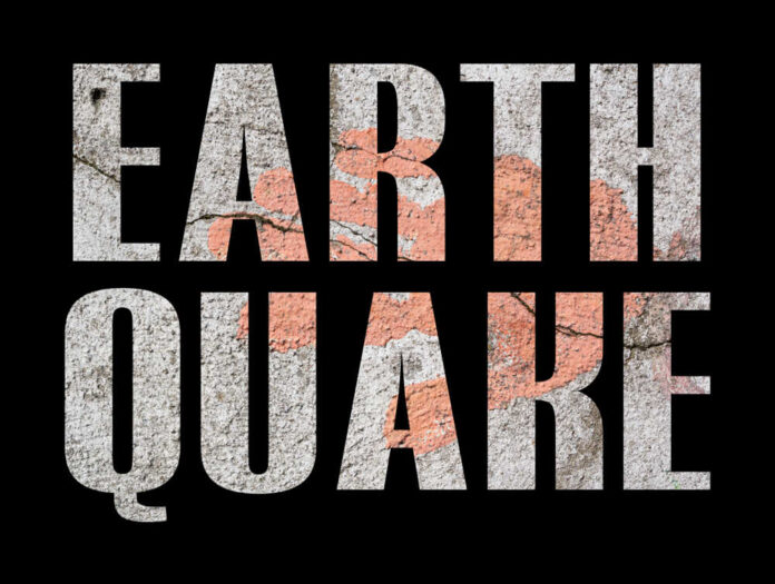Earthquake,-,With,Old,Concrete,Wall,On,Black,Background Concert crowd with hands raised, bright stage lights.