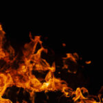 Orange flames against a dark black background
