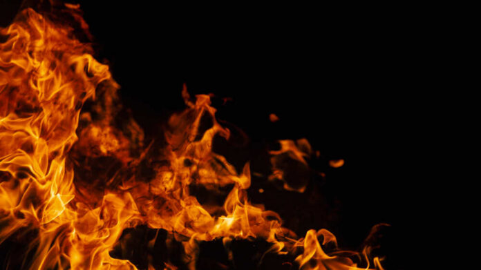 On,Fire.,Themes,Of,Fire,,Disaster,And,Extreme,Events.,Background Orange flames against a dark black background