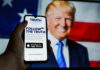 Bitcoin Whiplash Impacts Truth Social Smartphone displaying Truth Social app, Donald Trump background.
