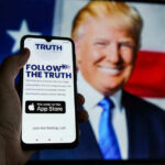 Bitcoin Whiplash Impacts Truth Social Smartphone displaying Truth Social app, Donald Trump background.