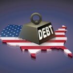 Debt Bomb Nears $2 Trillion — Again! A heavy weight labeled 'DEBT' sits on a map of the United States, symbolizing economic challenges.