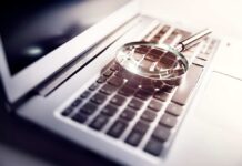 Vanished Mom, Ominous Clues Emerge A magnifying glass resting on a laptop keyboard