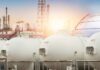 Gas storage tanks in an industrial facility during sunrise