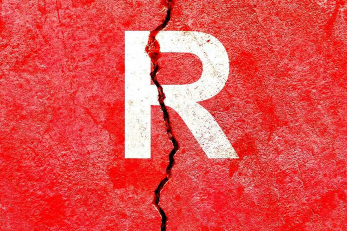 shutterstock_2222197027 Cracked red wall with white letter R.