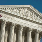 U.S. Supreme Court building with American flag.