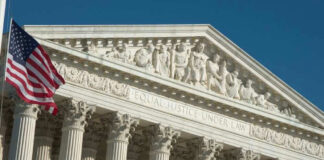 U.S. Supreme Court building with American flag.