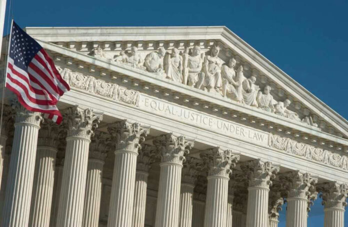 U.S. Supreme Court building with American flag.
