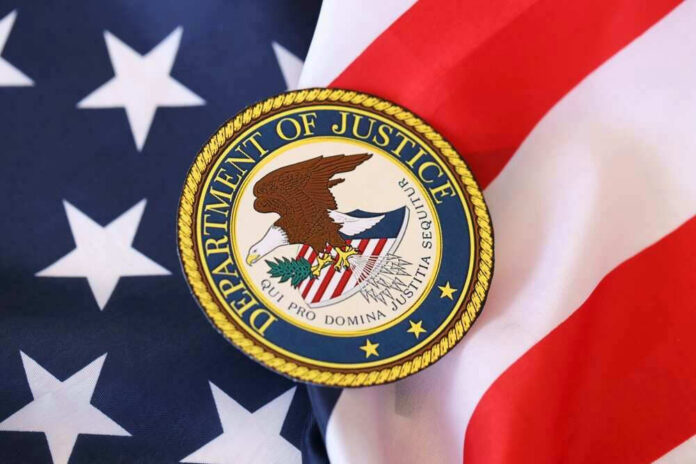 shutterstock_2439221439 Department of Justice seal on American flag.