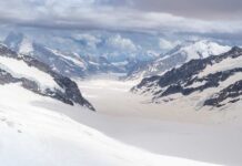 34-Year Mystery Ends In Ice Blue glacier ice with crevasses and rocky surface