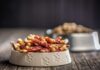 Metal Shards Trigger Coast-To-Coast Recall Dog kibble in a gray bowl with paw prints