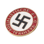Drought Exposes Nazi Fleet — Still Loaded Nazi party badge with swastika on white circle and red border