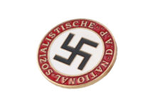 Drought Exposes Nazi Fleet — Still Loaded Nazi party badge with swastika on white circle and red border