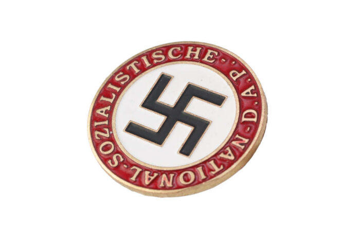 Nazi party badge with swastika on white circle and red border