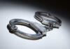 Wildfire Villain Nabbed As City Erupts Close-up of metallic handcuffs on a light surface
