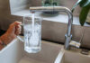 Abortion Pills Found in Tap Water? Hand filling pitcher with water from faucet.