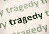 Close-up of the word 'tragedy' printed multiple times in varying shades