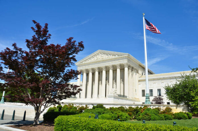 Supreme,Court,In,Washington,Dc United States Supreme Court building with columns and an American flag