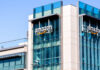 Amazon Pay Hike Hype – Huge Catch Inside Exterior view of an Amazon corporate building with a glass facade