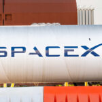 Large silver cylindrical tank with a blue logo