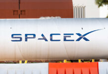 VIDEO: SpaceX’s Giant Climbs, Lands In Flames Large silver cylindrical tank with a blue logo
