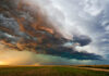 Dramatic storm clouds over a flat landscape.