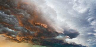 Dramatic storm clouds over a flat landscape.