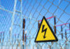 Power Plant Free-For-All Begins High voltage warning sign on a chain-link fence at an electrical substation