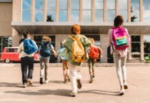 Parents Blindsided: THESE Schools Are Hiding Identity Swaps Group of schoolchildren with backpacks running toward a school entrance