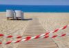 Tourists Trap Themselves Chasing ‘Epic’ Shot A wooden pathway leading to the beach with restricted access tape and chairs in the background
