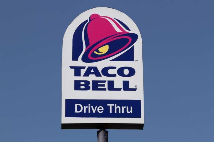 Indianapolis,-,Circa,August,2022:,Taco,Bell,Fast,Food,Restaurant. Taco Bell drive-thru sign against a clear blue sky