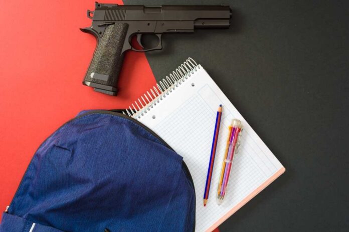 Students,Carry,Guns,To,Class,To,Protect,Themselves,During,Shootings. Handgun beside school supplies and a blue backpack