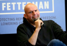 John Fetterman holding microphone.