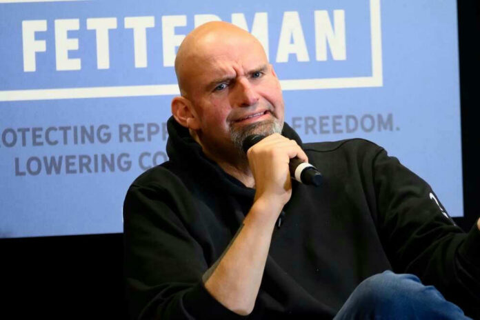 shutterstock_2222472661 John Fetterman holding microphone.