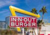 In-N-Out Makes Changes In-N-Out Burger sign with yellow arrow in city setting