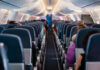 Airline Rips Out Coach To Cash In Airplane interior with passengers seated mid-flight.