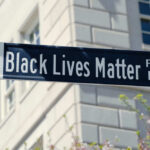 Black Lives Matter street sign against building background