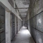 Last-Minute Death Row Bombshell Empty prison corridor with barred cells on either side