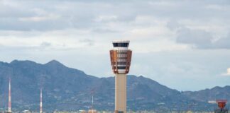 Airport control tower with mountains in the background