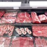 Variety of fresh meats displayed in a butcher shop