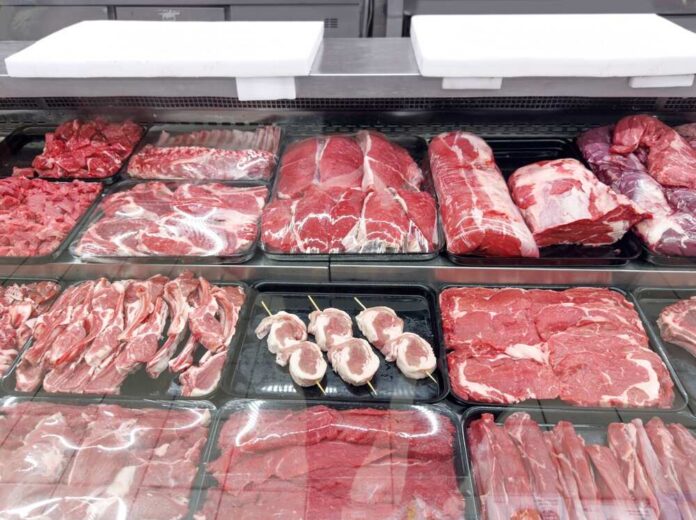 Choosing,Pork,,Beef,And,Other,Meats,At,The,Grocery,Store Variety of fresh meats displayed in a butcher shop