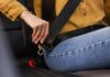 ALERT: Steering Fiasco – 208,724 SUVs at Risk Person fastening a seat belt in a car