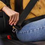 ALERT: Steering Fiasco – 208,724 SUVs at Risk Person fastening a seat belt in a car