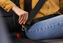 ALERT: Steering Fiasco – 208,724 SUVs at Risk Person fastening a seat belt in a car