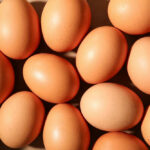 Tainted Eggs Lead To Multiple Hospitalizations Brown eggs arranged closely together in bright light
